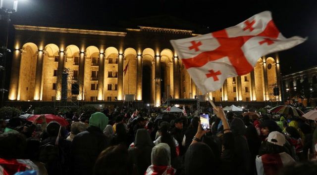Thousands of Georgians defy warnings to join protests